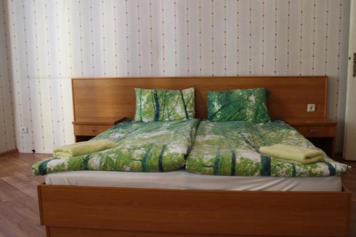 a bedroom with a large bed with a wooden headboard at Casablanca City in Varna City