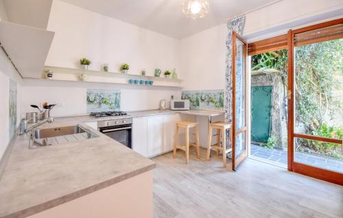 a kitchen with white walls and a large window at Terrazza Sul Golfo Paradiso in Recco