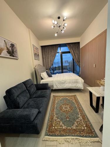 a living room with a couch and a bed at Smart & Modern Living in Heaven! in Dubai