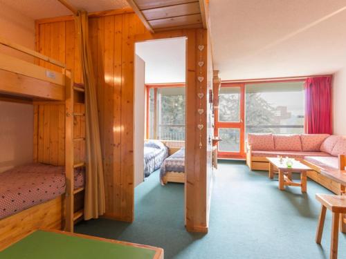 ein Zimmer mit zwei Etagenbetten und einer Couch in der Unterkunft Appartement 6 pers. au centre, balcon, wifi gratuit - FR-1-346-408 in Arc 1800