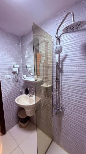 a bathroom with a glass shower and a sink at Locanda pyramids view in Cairo