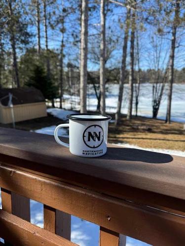 a coffee cup sitting on top of a wooden bench at Lilly Pad Landing in Hazelhurst
