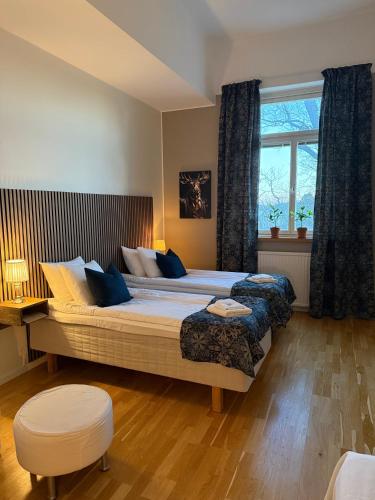 a bedroom with a large bed and a window at Rindö Hamn Bed & Breakfast in Vaxholm