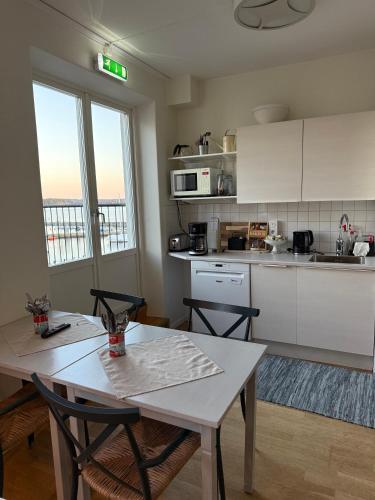 a kitchen with a table and two chairs in a room at Rindö Hamn Bed & Breakfast in Vaxholm