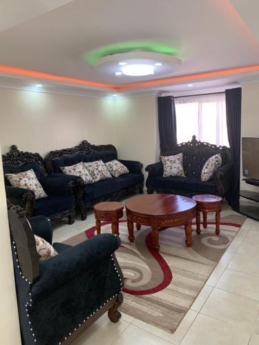 a living room with couches and a coffee table at Mwashora in Nairobi