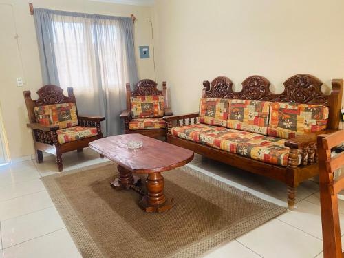 a living room with a couch and two chairs and a table at Casa Amanda in Villa de Alvarez