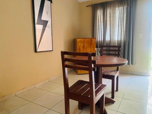 a dining room with a wooden table and chairs at Casa Amanda in Villa de Alvarez