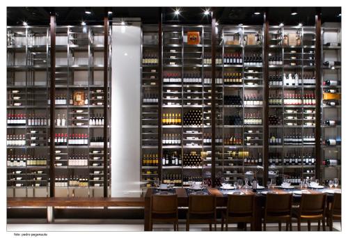 a wine cellar with a table and chairs and a wall of wine bottles at ETH Rioja in Haro