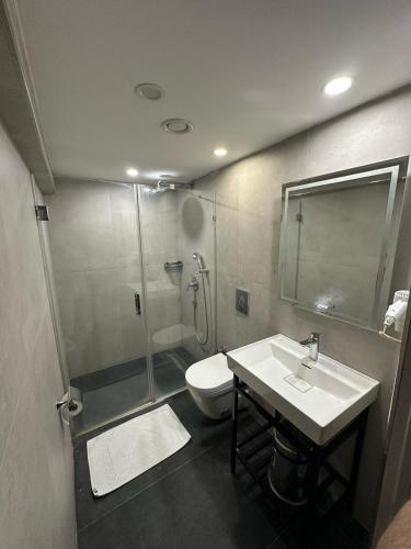 a bathroom with a shower and a sink and a toilet at VAMA TAKSİM Hotel in Istanbul