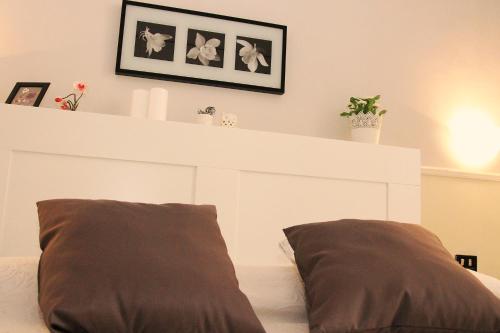 a white headboard with two pillows on a bed at Hotel Luna Rossa in Naples