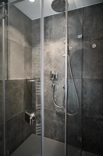 a bathroom with a shower with a glass door at Unternberg Hof Ruhpolding in Ruhpolding