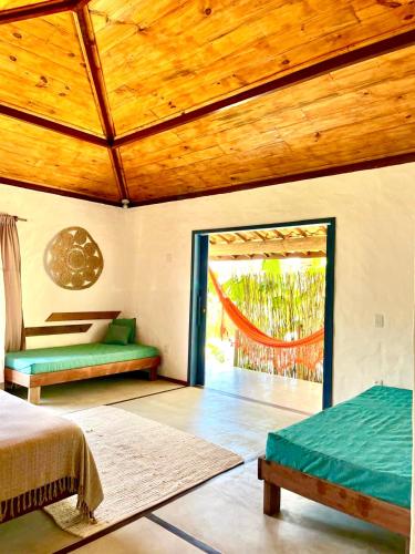 a bedroom with a bed and a large window at Pousada La vida boutique in Icaraí