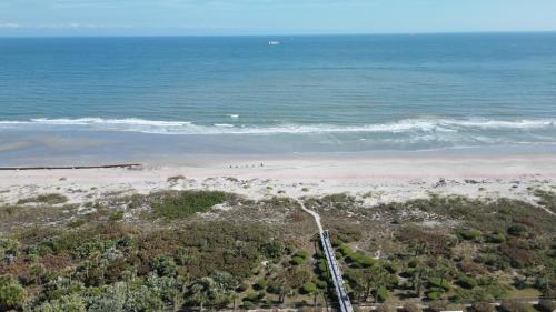 an aerial view of a beach and the ocean at Enchanting 2-Bedroom Ground Floor Beach Condo at Cape Canaveral WiFi & AC in Cape Canaveral
