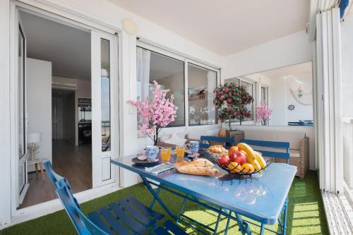 - une table bleue avec des fruits dans une pièce dans l'établissement La perle du Grau : T1 avec exceptionnelle vue mer, au Grau-du-Roi