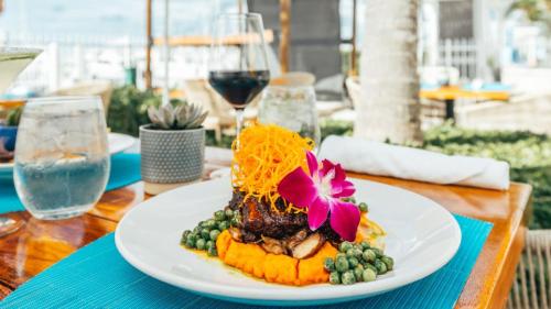 a plate of food on a table with wine glasses at Oceans Edge Key West in Key West