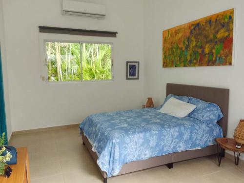 a bedroom with a bed and a window at Villa Don Julio in Juan Dolio