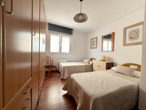 a room with two beds and a cabinet with two beds at Monuca - 3803 in Santoña