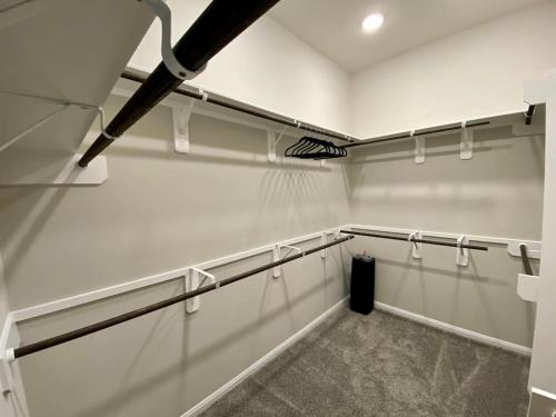 a room with white walls and a row of racks at 4-BR Getaway Ideal for Families in Richmond