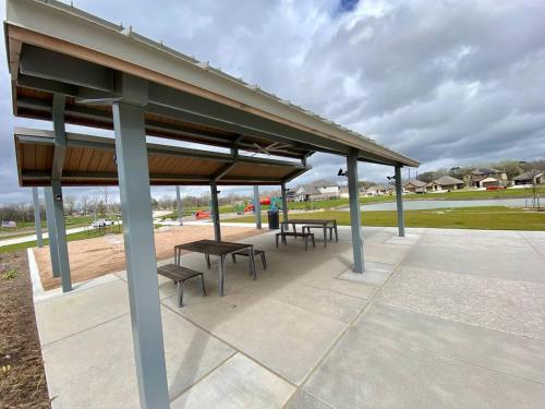 a group of picnic tables and benches under a pavilion at 4-BR Getaway Ideal for Families in Richmond