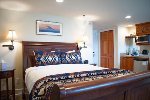 a bedroom with a bed with a wooden head board at Lakeshore Lodging Lodge 615 in Homer