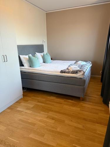 a bedroom with a bed with blue pillows on it at Rindö Hamn Bed & Breakfast in Vaxholm