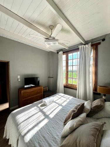 a bedroom with a large bed and a window at La Pulperia in Capilla del Señor
