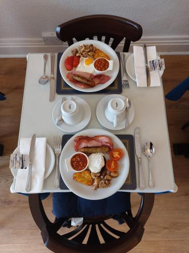 a table with two plates of breakfast food on it at Westfield House in Blackpool