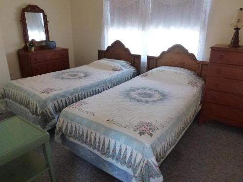 a bedroom with two beds and a dresser and a window at Wi-Fi, Patio, Yard, Balcony, Deck, Ocean Side Duplex 1St Floor In Ship Bottom 10609 in Ship Bottom