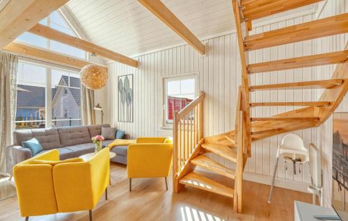 a living room with a staircase and yellow chairs at 2 Bedroom Nice Home In Zerpenschleuse in Zerpenschleuse