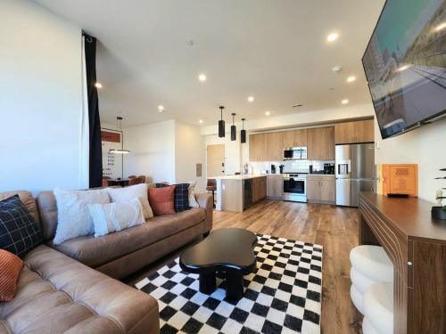 a living room with a couch and a table at The James Suite One-Newly Built, 2 BR, Beach Block in Atlantic City