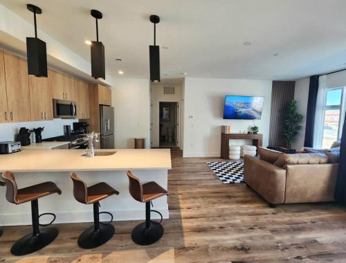 a kitchen and living room with a counter and a couch at The James Suite One-Newly Built, 2 BR, Beach Block in Atlantic City