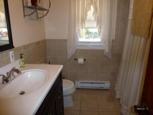 um banheiro com uma pia, um vaso sanitário e uma janela em Wifi, Deck,yard, Ocean Side Duplex 2Nd Floor In Ship Bottom 10609 em Ship Bottom