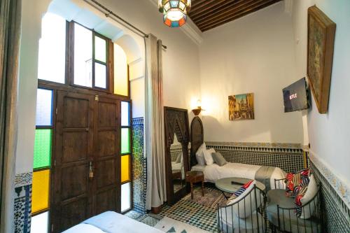 a living room with a door and a room with a room at Riad Fes la Mama - Rooftop in Fez