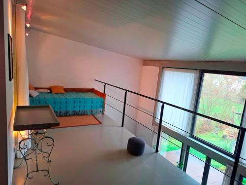 a room with a balcony with a bed and a window at Atelierhaus in Rehborn