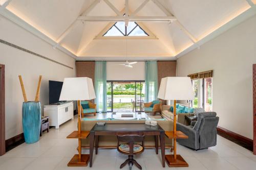 a living room with a table and two lamps at Villa Ebony -Tropical Design with Ocean Views, 5-star resort in Albion