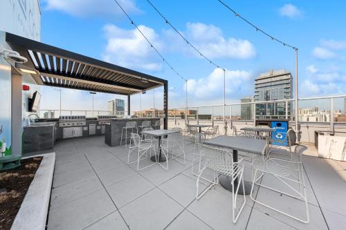 a patio with tables and chairs on a roof at Kasa River North Chicago in Chicago