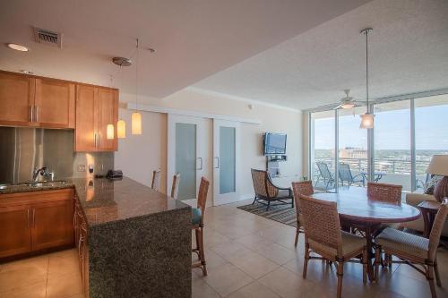 a kitchen and dining room with a table and chairs at Ocean Club 1206 Premier in Biloxi