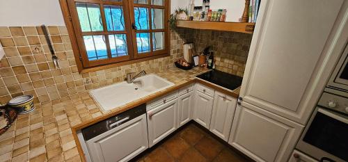 a small kitchen with a sink and a window at Spacious Villa with Pool and Fireplace in Roquebrune-sur-Argens