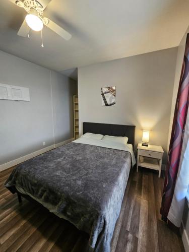 a bedroom with a bed and a ceiling fan at Next to Downtown Greensboro Bungalow Rooms in Greensboro