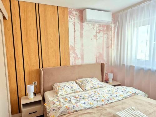 a bedroom with a bed and a window at Apartament Balladyny in Lublin