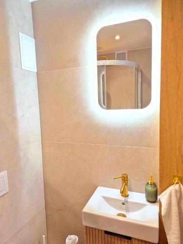 a bathroom with a sink and a mirror at Apartament Balladyny in Lublin