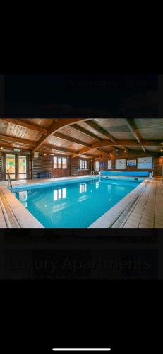 a large swimming pool in a large building at Wensleydale 17 Caravan in Tosside