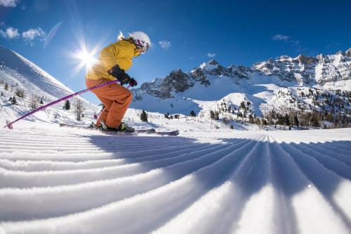 a person is skiing down a snow covered mountain at Chalet Les écrins Guillestre Vars Risoul Queyras in Guillestre