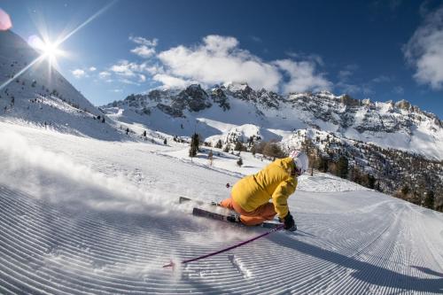 a person is skiing down a snow covered mountain at Chalet Les écrins Guillestre Vars Risoul Queyras in Guillestre
