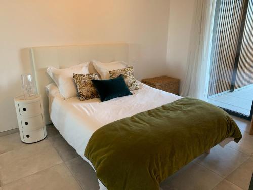 une chambre avec un lit avec des oreillers et une fenêtre dans l'établissement Superbe T2 avec terrasse, à Bastia