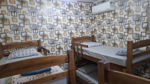 two bunk beds in a room with a wallpaper at Casa mobiliada para até 14 pessoas in Ribeirão Preto