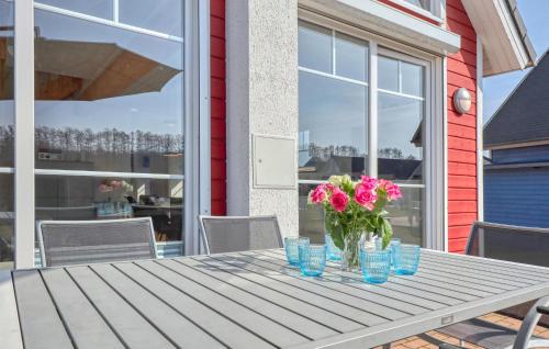 a table with a vase of flowers on it at 2 Bedroom Nice Home In Zerpenschleuse in Zerpenschleuse