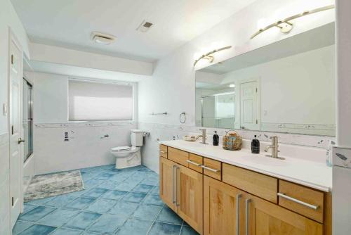 a bathroom with a sink and a toilet and a mirror at Icon Playce: Beachfront with 360 rooftop in Atlantic City