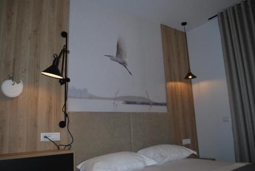 a bird flying over a bed in a hotel room at Sofo Hotel Dhermi in Dhërmi