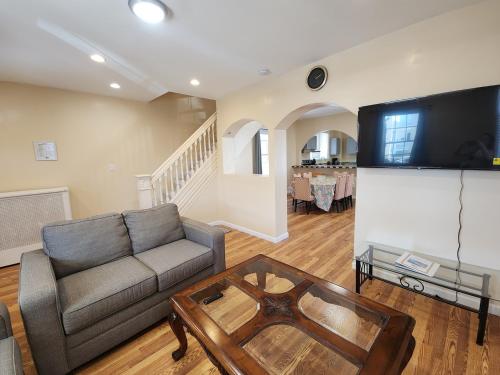 a living room with a couch and a flat screen tv at The Delancy House-Near the Bay, Casinos &Boardwalk in Atlantic City